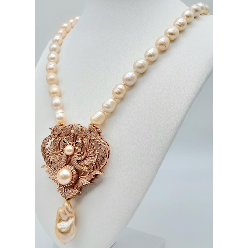 175 - A fabulous natural pearl necklace with a statement pendant loaded with cubic zirconia and a large ba... 