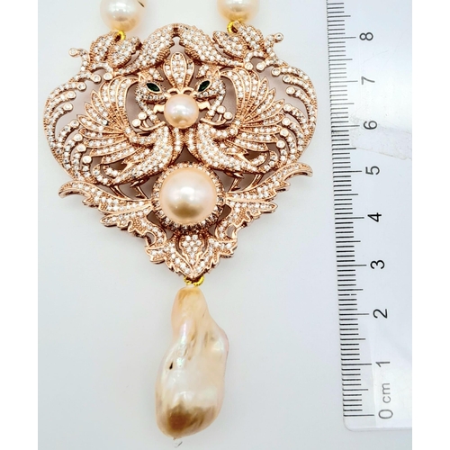 175 - A fabulous natural pearl necklace with a statement pendant loaded with cubic zirconia and a large ba... 