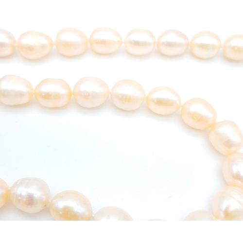 175 - A fabulous natural pearl necklace with a statement pendant loaded with cubic zirconia and a large ba... 