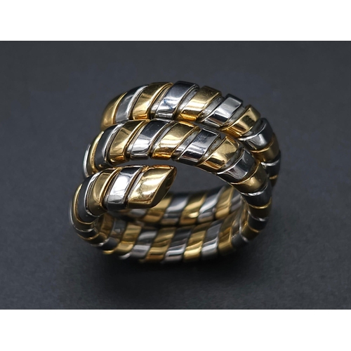 23 - A Bulgari Tubogas Flexible 18K Gold Ring. 16 yellow gold pipe bands alternate with stainless steel b... 