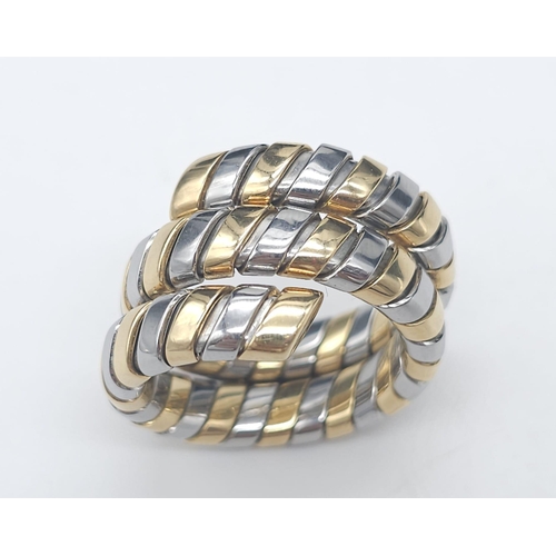 23 - A Bulgari Tubogas Flexible 18K Gold Ring. 16 yellow gold pipe bands alternate with stainless steel b... 