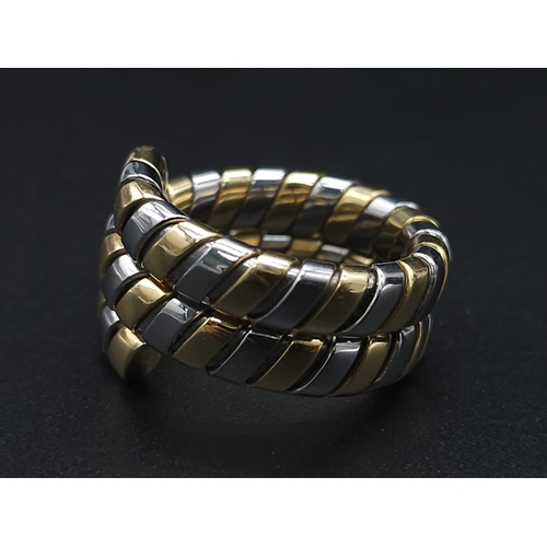 23 - A Bulgari Tubogas Flexible 18K Gold Ring. 16 yellow gold pipe bands alternate with stainless steel b... 