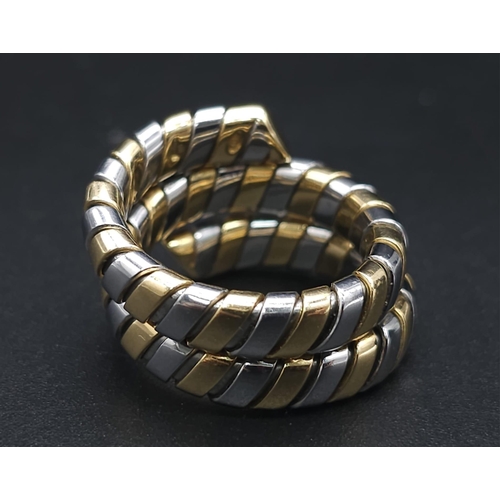 23 - A Bulgari Tubogas Flexible 18K Gold Ring. 16 yellow gold pipe bands alternate with stainless steel b... 