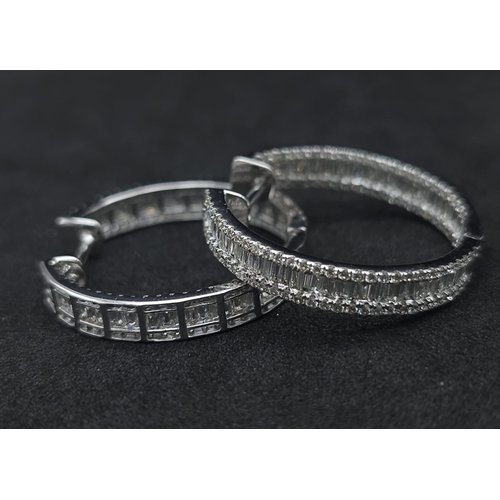 43 - A Pair of 18K White Gold 2ctw Diamond Hoop Earrings. An exquisite combination of baguette and round ... 