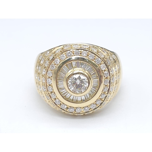 93 - An 18K Yellow Gold and Diamond Bullseye Dress Ring. A central brilliant round cut diamond surrounded... 