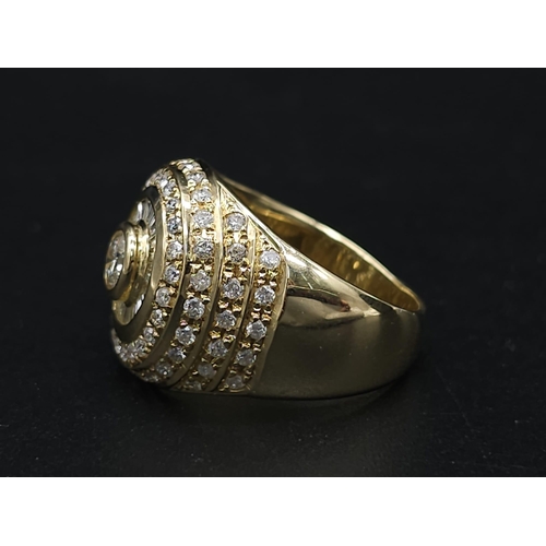 93 - An 18K Yellow Gold and Diamond Bullseye Dress Ring. A central brilliant round cut diamond surrounded... 