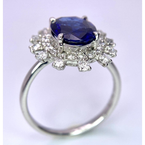 198 - A 950 Platinum, Diamond and Sapphire Ring. Central 2.79ct Sri Lankan oval sapphire with a double hal... 