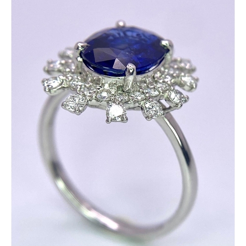 198 - A 950 Platinum, Diamond and Sapphire Ring. Central 2.79ct Sri Lankan oval sapphire with a double hal... 