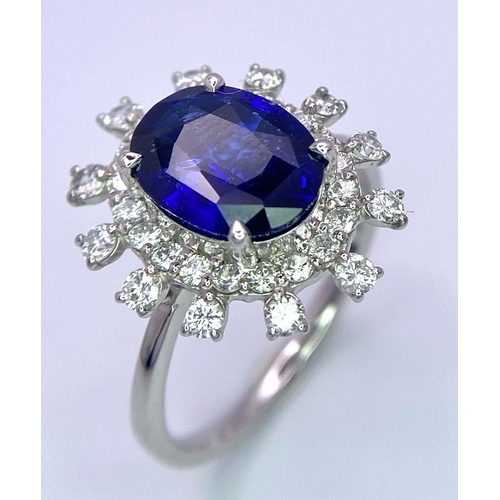 198 - A 950 Platinum, Diamond and Sapphire Ring. Central 2.79ct Sri Lankan oval sapphire with a double hal... 