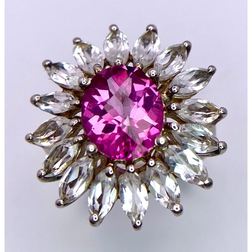 1145 - A fancy 925 silver cluster ring. With large faceted Spinel centre and surrounded by zirconia. Total ... 