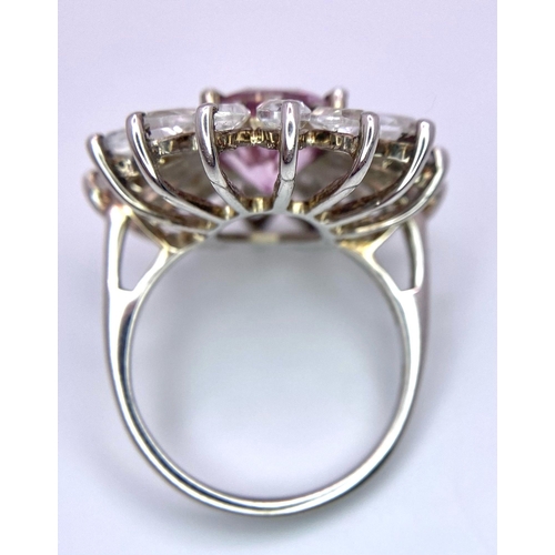 1145 - A fancy 925 silver cluster ring. With large faceted Spinel centre and surrounded by zirconia. Total ... 