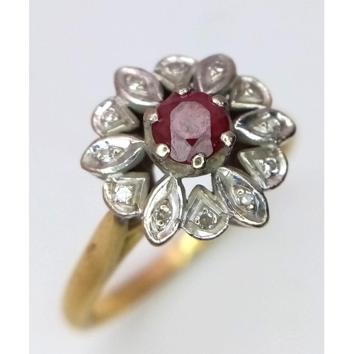 1374 - A Vintage 18K Yellow Gold Ruby and Diamond Floral Ring. Central ruby with a halo of small diamonds. ... 