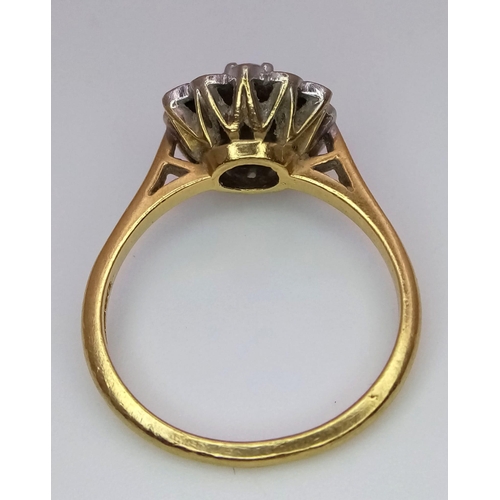 1374 - A Vintage 18K Yellow Gold Ruby and Diamond Floral Ring. Central ruby with a halo of small diamonds. ... 