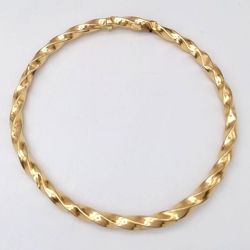 1556 - A 9K Yellow Gold Twist Bangle. 3.22g weight.