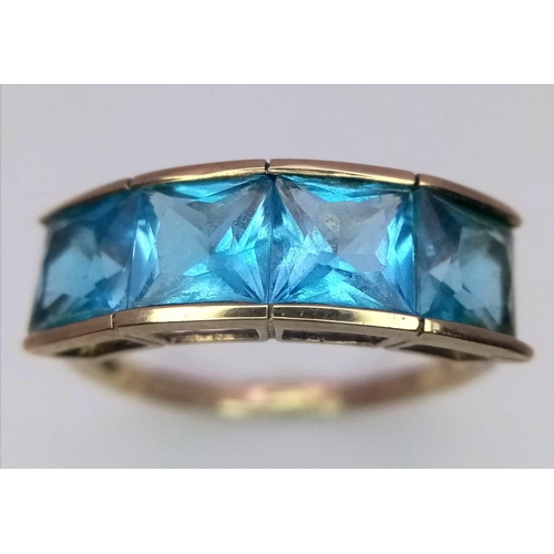 1677 - A 9K Yellow Gold Blue Stone Ring. Size T. 3.28g total weight.