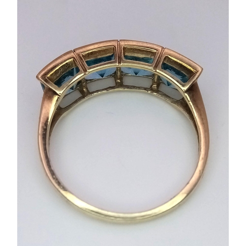 1677 - A 9K Yellow Gold Blue Stone Ring. Size T. 3.28g total weight.