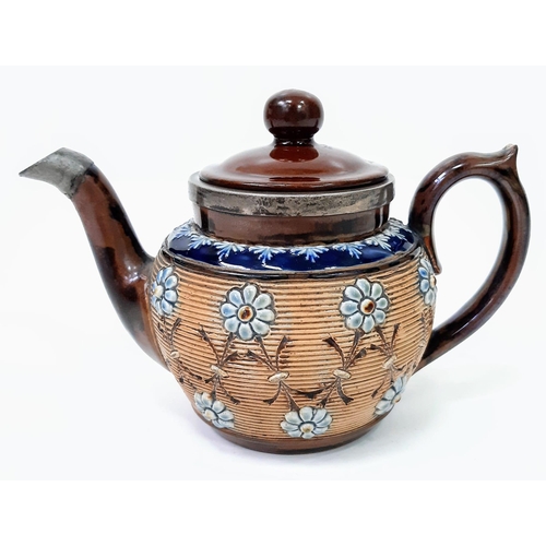 925 - An Antique (1890s) Doulton Lambeth Silver Trimmed Teapot. 20cm across. 14cm tall. Decorative floral ... 