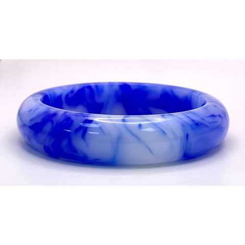 962 - A Blue and White Swirl Jade Bangle. 6cm inner diameter. 15mm width.