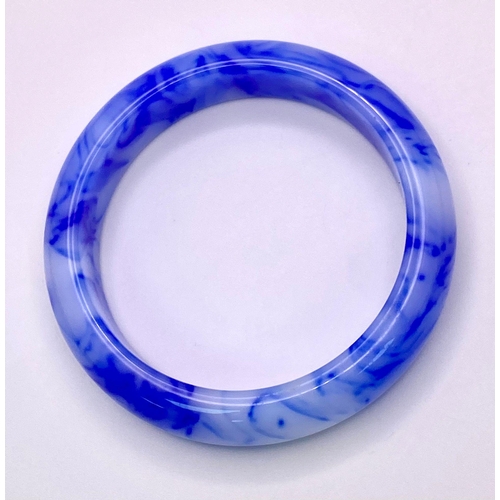 962 - A Blue and White Swirl Jade Bangle. 6cm inner diameter. 15mm width.