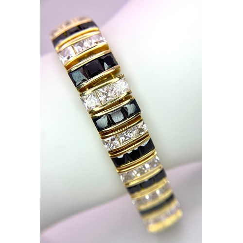 985 - A fancy 925 gilded silver black & white Zirconia bracelet. Total weight 41.8G. Total length 22cm.