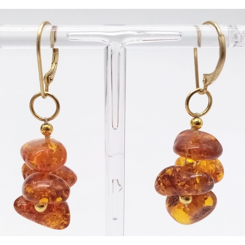 1066 - A Pair of Amber Cluster Earrings set in 9K Gold Earrings. 6g total weight. 3cm drop