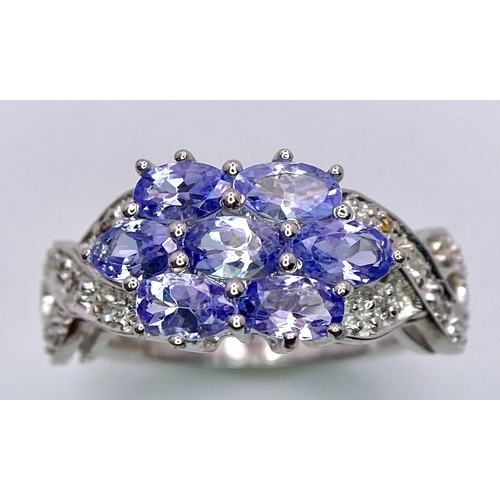 1159 - A 925 silver blue Topaz floral cluster ring. Surrounded by Zirconia. Total weight 3.9G. Size L/M. Ha... 