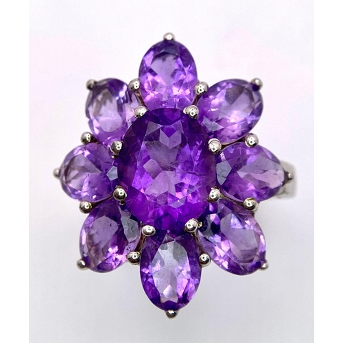 1370 - A fancy 925 silver Amethyst floral cluster ring. Total weight 5.5G. Size L/M.