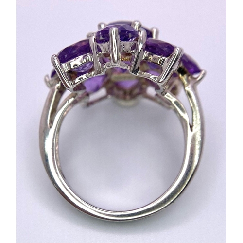 1370 - A fancy 925 silver Amethyst floral cluster ring. Total weight 5.5G. Size L/M.