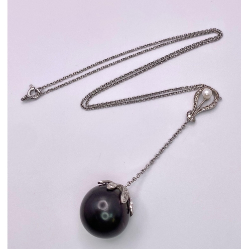 163 - An 18KT White Gold Necklace with a Tahitian Pearl, 5.5CTW Diamond encrusted Pendant. The beautifully... 