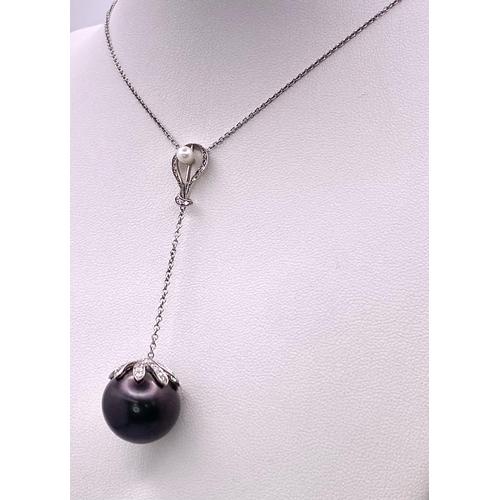 163 - An 18KT White Gold Necklace with a Tahitian Pearl, 5.5CTW Diamond encrusted Pendant. The beautifully... 