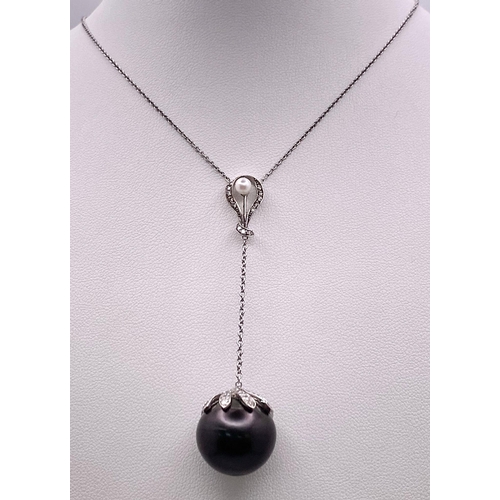 163 - An 18KT White Gold Necklace with a Tahitian Pearl, 5.5CTW Diamond encrusted Pendant. The beautifully... 