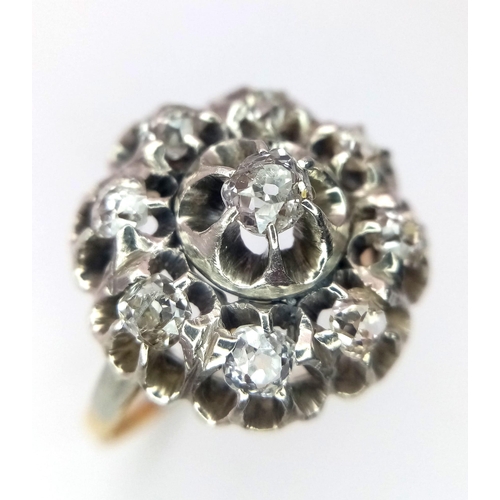 191 - An 18K Yellow and White Gold Diamond Ring. Central brilliant round cut diamond with an eight brillia... 