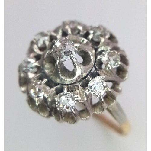 191 - An 18K Yellow and White Gold Diamond Ring. Central brilliant round cut diamond with an eight brillia... 