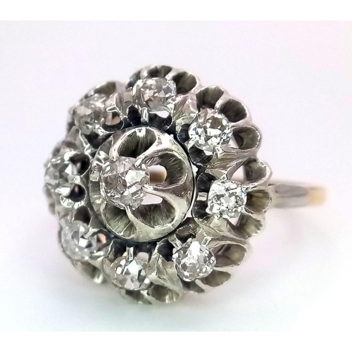 191 - An 18K Yellow and White Gold Diamond Ring. Central brilliant round cut diamond with an eight brillia... 