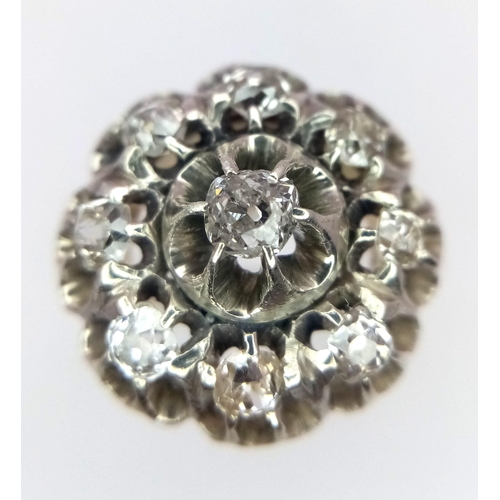 191 - An 18K Yellow and White Gold Diamond Ring. Central brilliant round cut diamond with an eight brillia... 