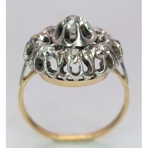 191 - An 18K Yellow and White Gold Diamond Ring. Central brilliant round cut diamond with an eight brillia... 