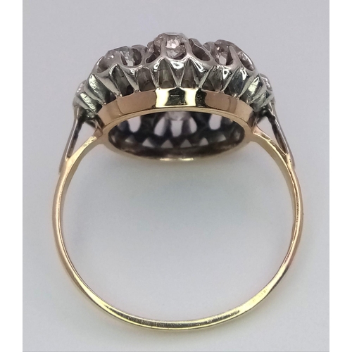 191 - An 18K Yellow and White Gold Diamond Ring. Central brilliant round cut diamond with an eight brillia... 