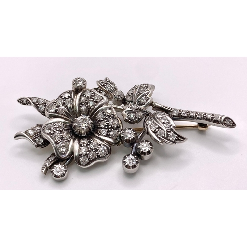 298 - An Antique 18K Gold and Diamond Floral Brooch. This beautifully constructed masterpiece has a brilli... 