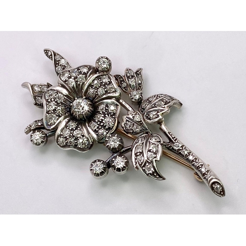 298 - An Antique 18K Gold and Diamond Floral Brooch. This beautifully constructed masterpiece has a brilli... 