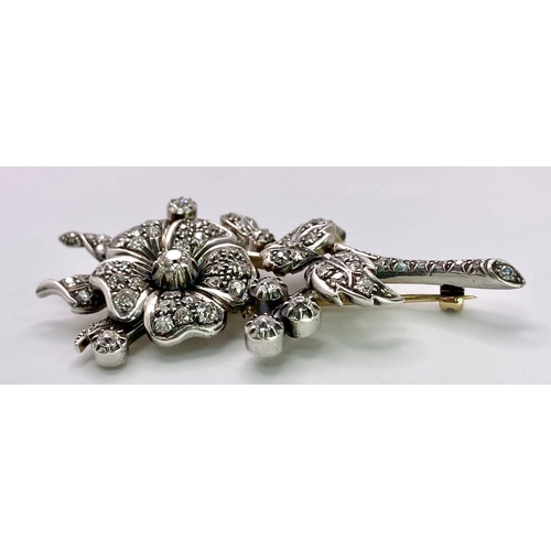 298 - An Antique 18K Gold and Diamond Floral Brooch. This beautifully constructed masterpiece has a brilli... 