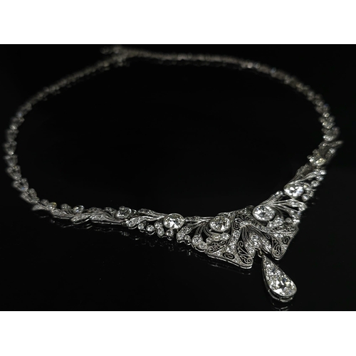 30 - A Majestic Art Deco 7ctw Diamond (approx) Platinum Lavaliere Necklace. Scrolled and foliate decorati... 