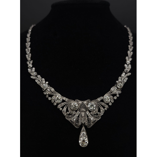 30 - A Majestic Art Deco 7ctw Diamond (approx) Platinum Lavaliere Necklace. Scrolled and foliate decorati... 