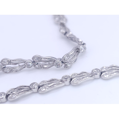 30 - A Majestic Art Deco 7ctw Diamond (approx) Platinum Lavaliere Necklace. Scrolled and foliate decorati... 