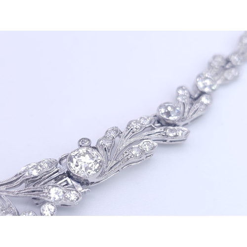 30 - A Majestic Art Deco 7ctw Diamond (approx) Platinum Lavaliere Necklace. Scrolled and foliate decorati... 