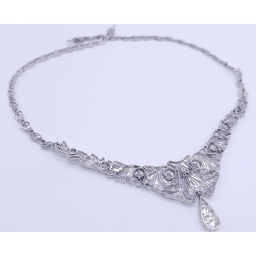 30 - A Majestic Art Deco 7ctw Diamond (approx) Platinum Lavaliere Necklace. Scrolled and foliate decorati... 