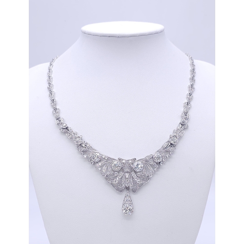 30 - A Majestic Art Deco 7ctw Diamond (approx) Platinum Lavaliere Necklace. Scrolled and foliate decorati... 