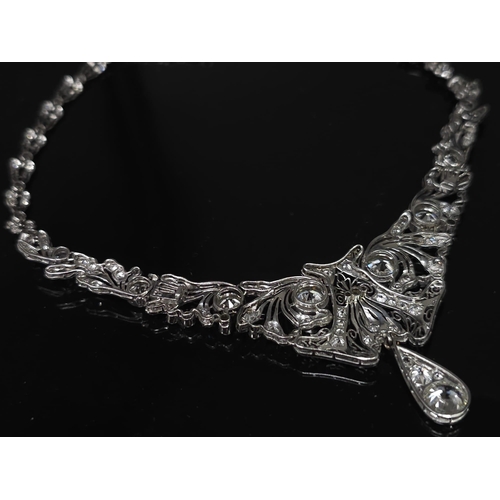 30 - A Majestic Art Deco 7ctw Diamond (approx) Platinum Lavaliere Necklace. Scrolled and foliate decorati... 