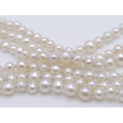 527 - A Triple Strand Fresh Pearl Bracelet with a 18kt White Gold, Diamond Set Bow Clasp.
Measuring 12cm i... 