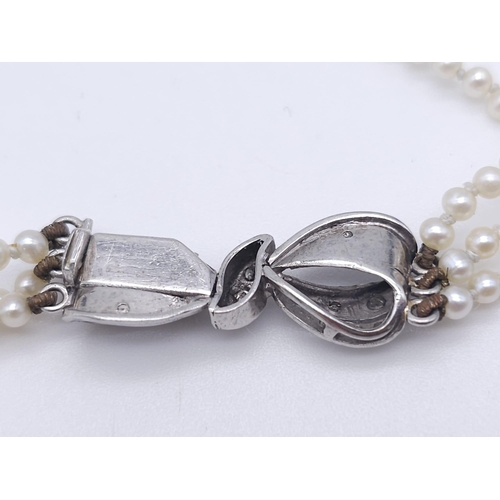 527 - A Triple Strand Fresh Pearl Bracelet with a 18kt White Gold, Diamond Set Bow Clasp.
Measuring 12cm i... 