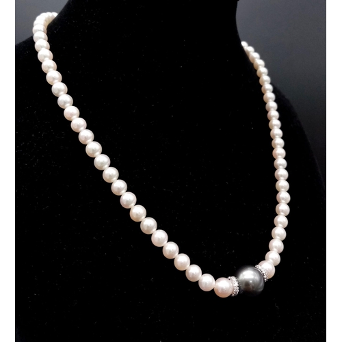 653 - A Wonderful South Sea, White Pearl Necklace with a Tahitian Black Pearl and Diamond Centrepiece. 750... 